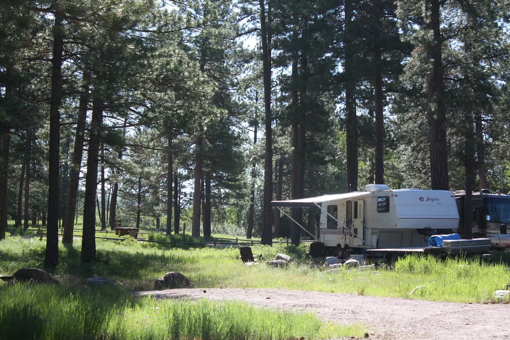 Fifth wheel trailer camping in an open landscape