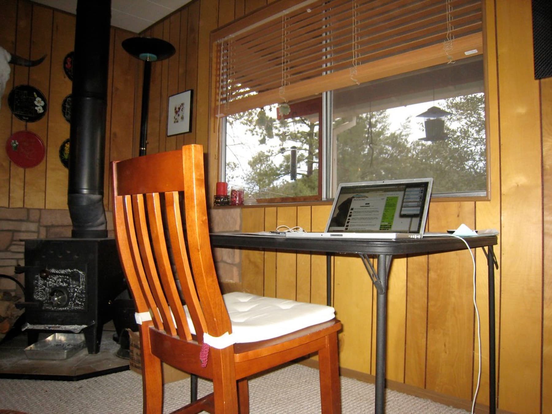 Laptop workspace set beside a large window with an outdoor view